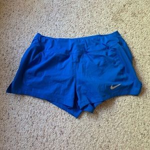 Blue Nike running shorts